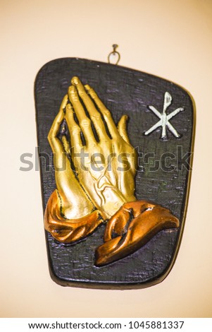 Praying hands for Jisus ,black and golden picture on yellow background