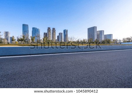 empty asphalt road with panoramic cityscape