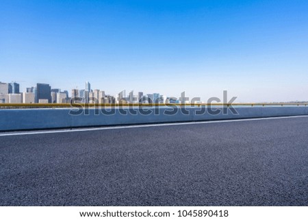 empty asphalt road with panoramic cityscape