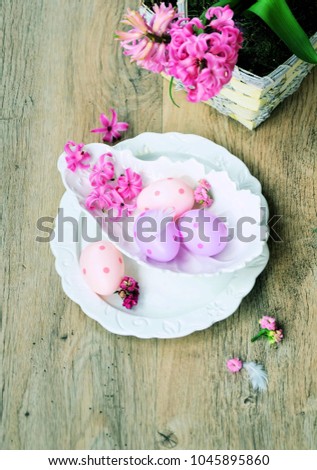  table setting  with spring flowers ,eggs and cutlery on wooden rustic table.