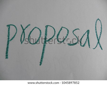 Text proposal hand written by green oil pastel on white color paper