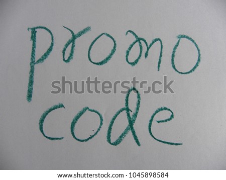 Text promo code hand written by green oil pastel on white color paper