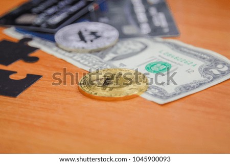 United States dollar, credit card and Bitcoin on the table in payment system concept.