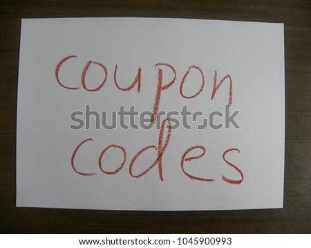 Text coupon codes hand written by brown oil pastel on white color paper
