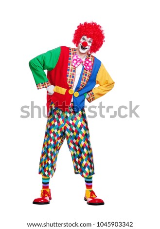 Full length  picture of a standing smiling clown against white background