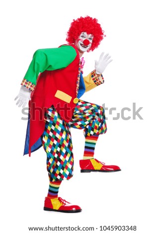 Side view full length picture of a clown imitating comic walk  Royalty-Free Stock Photo #1045903348