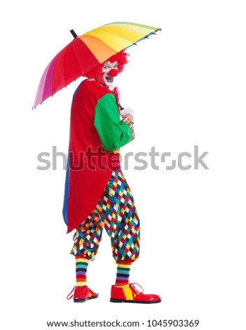 Full length picturure of a funny clown holding under rainbow umbrella looking back 
