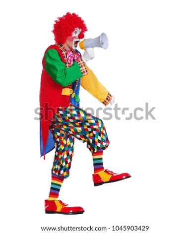Side view full length picture of a walking clown screaming into loudspeaker 