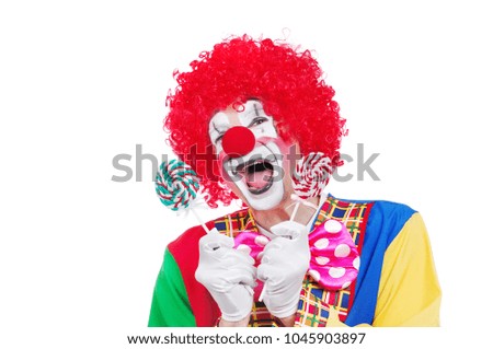 Extremely happy clown with sweets in hands