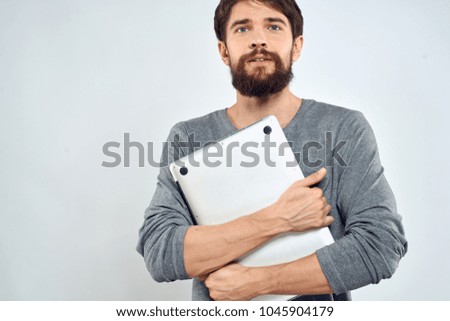 man with a laptop on a light background                               