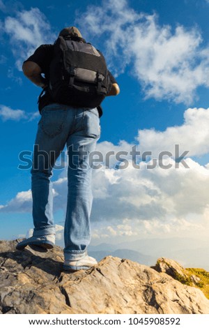 Landscape images vivid fresh bright colorful beautiful nature background And male tourist stands on a rocky mountain top, called Doi Pha Tang, which is a natural attraction in northern Thailand.