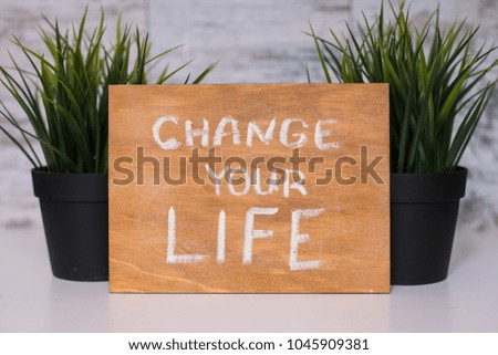 Wooden board with motivational text change your life