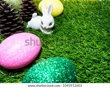 Easter bunny, Easter eggs and cute bunny in green grass. Happy Easter