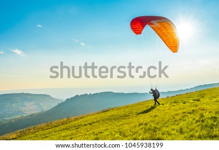 Paraglider on the ground Royalty-Free Stock Photo #1045938199
