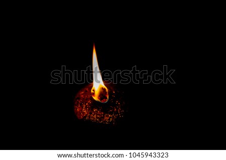 Flames from oil lamps at night. Has a black background