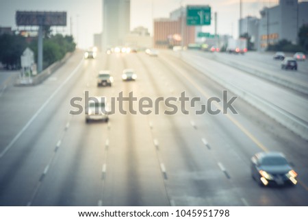 Blur motion traffic along Interstate Highway 69 at rush hour in Houston, Texas, US. Downtown skyline building are in background. Urban infrastructure at peak travel times concept