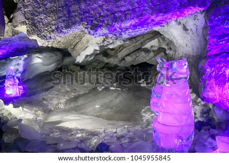 Great ice cavern. Kungur cave, ice glen. Perm Krai. Russia. Magnificent ice stalactites blue, clear dark-blue ice