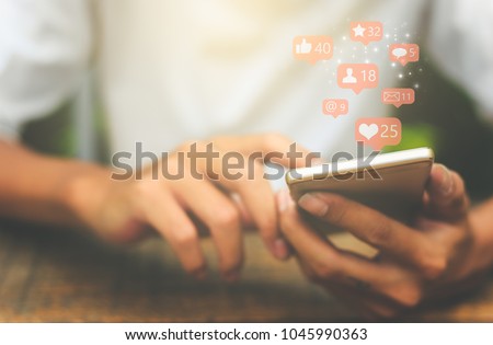 Young man using smart phone,Social media concept. Royalty-Free Stock Photo #1045990363