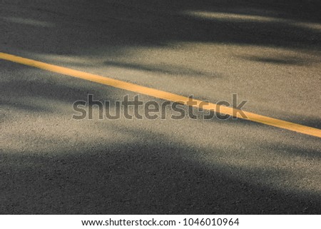 Yellow paint line on black asphalt. space transportation background