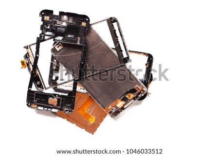 Parts of damaged broken smartphones on white background top view. 