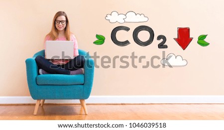 Reduce CO2 with young woman using her laptop in a chair