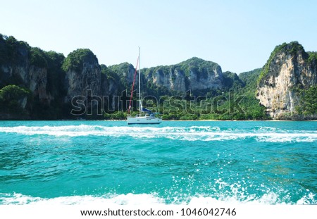One ship floating in the sea. There are islands in the back at Krabi Thailand.