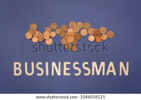 Businessman written with wooden letters on a blue background to mean a business concept