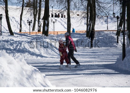Mother is teaching the child to skate