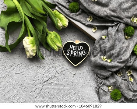 hello spring. chalkboard with hello spring text and smile with tulips
