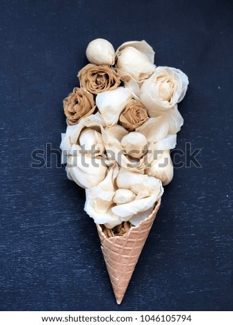 waffle cone with brown flowers on black background