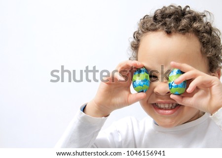 little boy with sweet chocolate Easter eggs stock photo Royalty-Free Stock Photo #1046156941