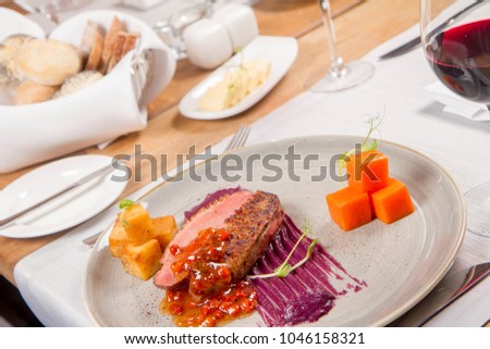 Roast duck breast, red cabbage with apple, roasted potatoes,mountain ash and honey sauce