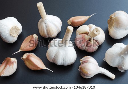 heads of garlic over dark