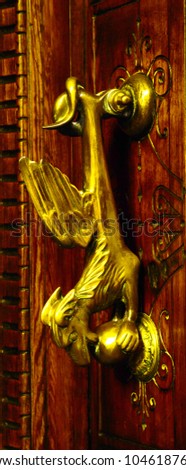 Door with brass knocker in the shape of a decor,  beautiful entrance to the house, vintage decoration