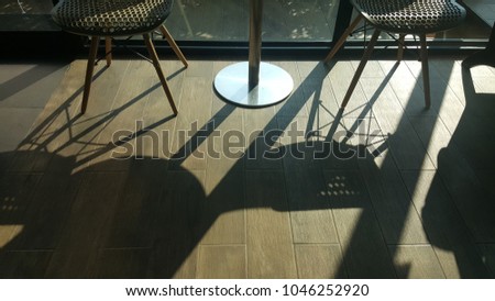 The beautuful light and shadow on the floor of the coffee shop in the morning. 
