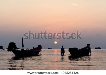 Silhouette fishing boat with fisherman