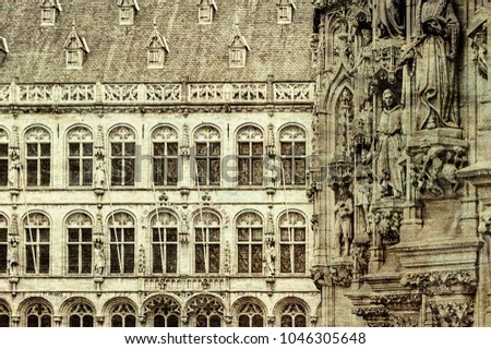 Leuven is the capital of the province of Flemish Brabant in Belgium.  View on a street with city hall and St. Peter's Church in background. Vintage style toned picture