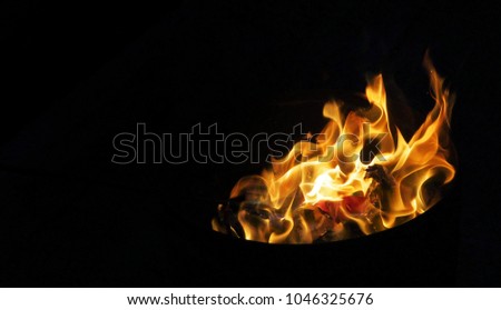 Fire at the right of image on black background with copy space