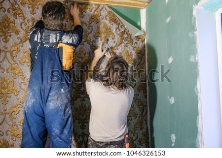 a man glues Wallpapers