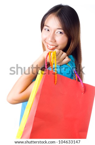 Portrait of stunning young woman carrying shopping bags against white background