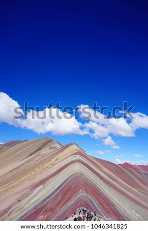Beautiful view of the "Rainbow Mountain" near Cusco, Peru. Colorful crowd situated in the lower part of the picture.