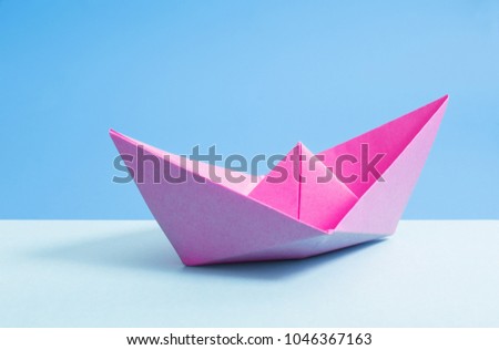 paper boat on blue paper background
