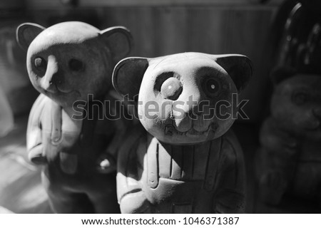 Black and white picture of two creepy looking wooden bear dolls