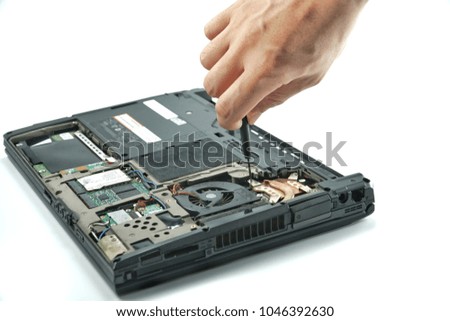 Computer repair concept.Close up the man repair Laptop motherboard with screwdriver. Maintenance cpu hardware upgrade of motherboard.Hard disk drive.PC repair electronic engineer of technology.