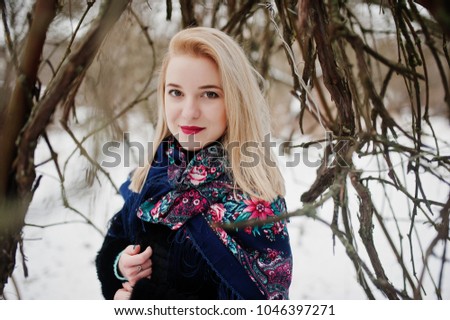 Blonde girl with hand embroidered scarf posed at winter day. Women's handkerchief.