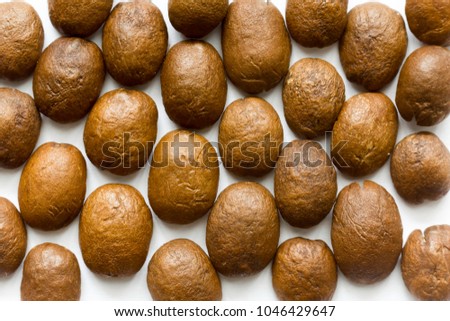 Patterns of coffee beans.Back of the beans. Different shapes and different shades of brown.White background.Site about food, drinks, health, business.