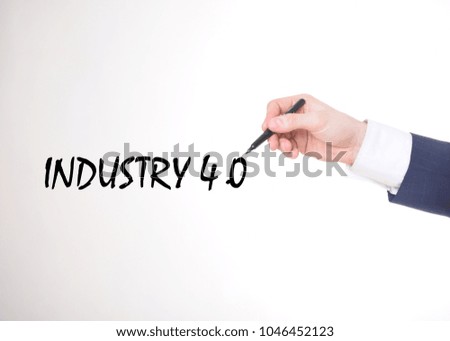 The businessman writes a black marker inscription:INDUSTRY 4.0