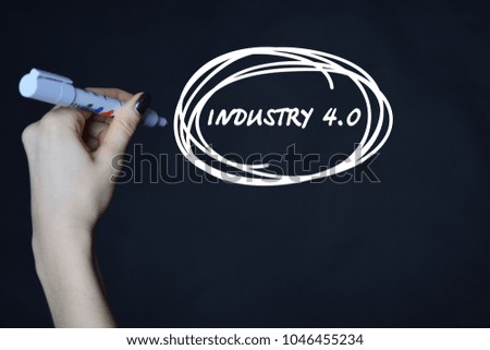 The businessman writes an inscription with a white marker:INDUSTRY 4.0