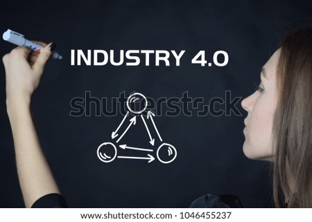 The businessman writes an inscription with a white marker:INDUSTRY 4.0