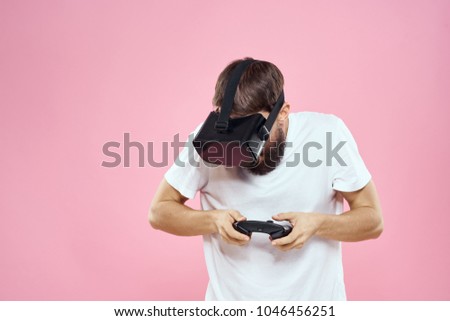  a man in 3d glasses plays games on a pink background, a virtual reality, technology                              